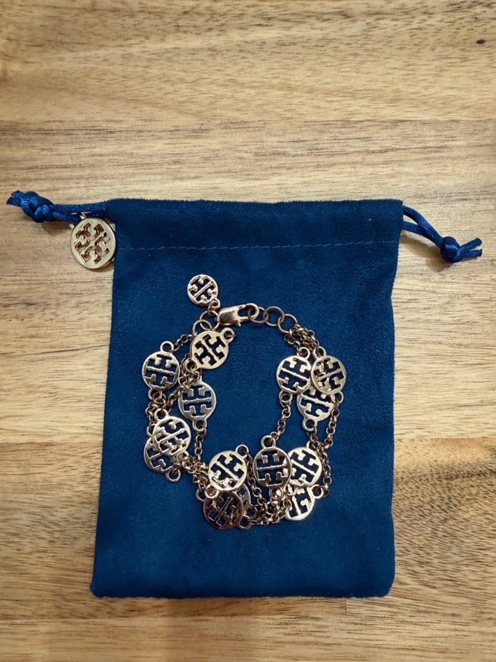 Tory Burch Gold Logo Link Bracelet on Navy Pouch